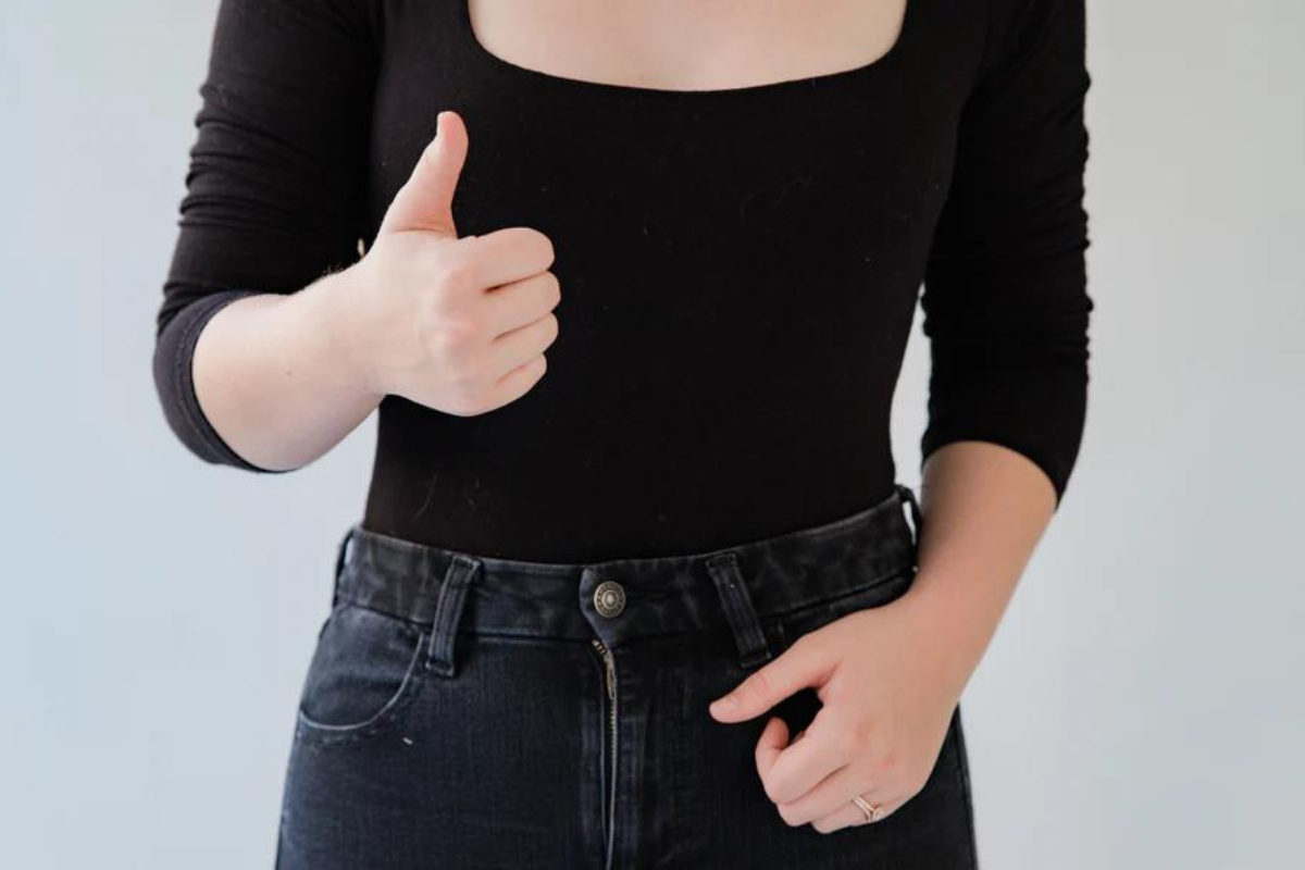 Woman with thumbs up. Cervical Cancer Prevention Week 2023