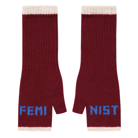 A flat lay photo of the Black & Beech Feminist Gloves in burgundy with bright blue writing and cream cuffs on a white background.