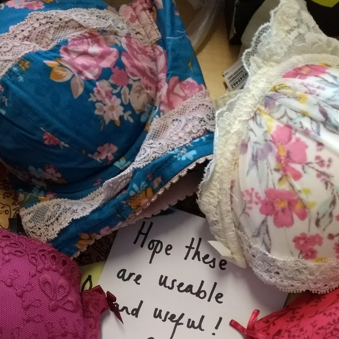 A handwritten note is surrounded by colourful bras