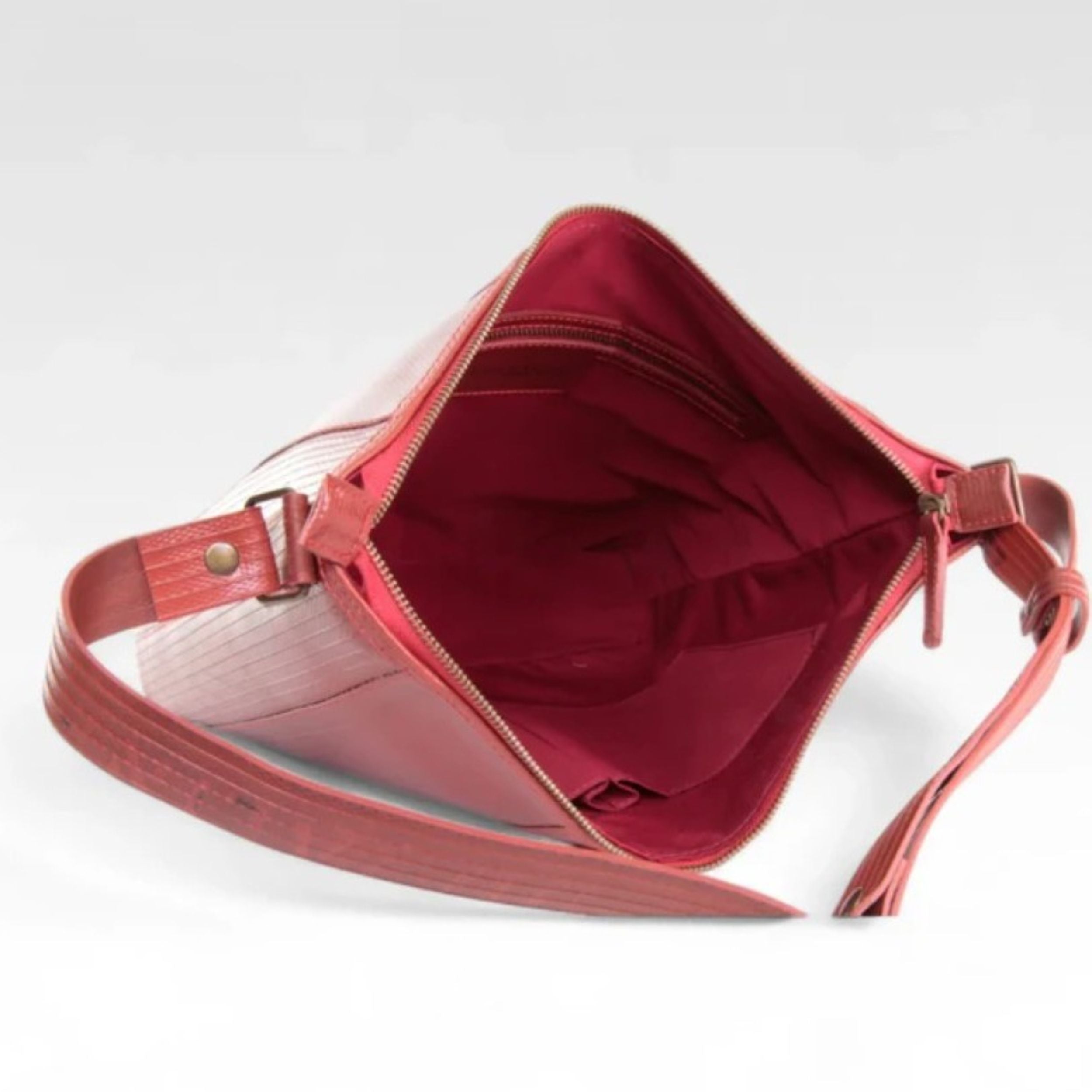 A photo of the Elvis & Kresse red Tooley Tote Bag open on a white background