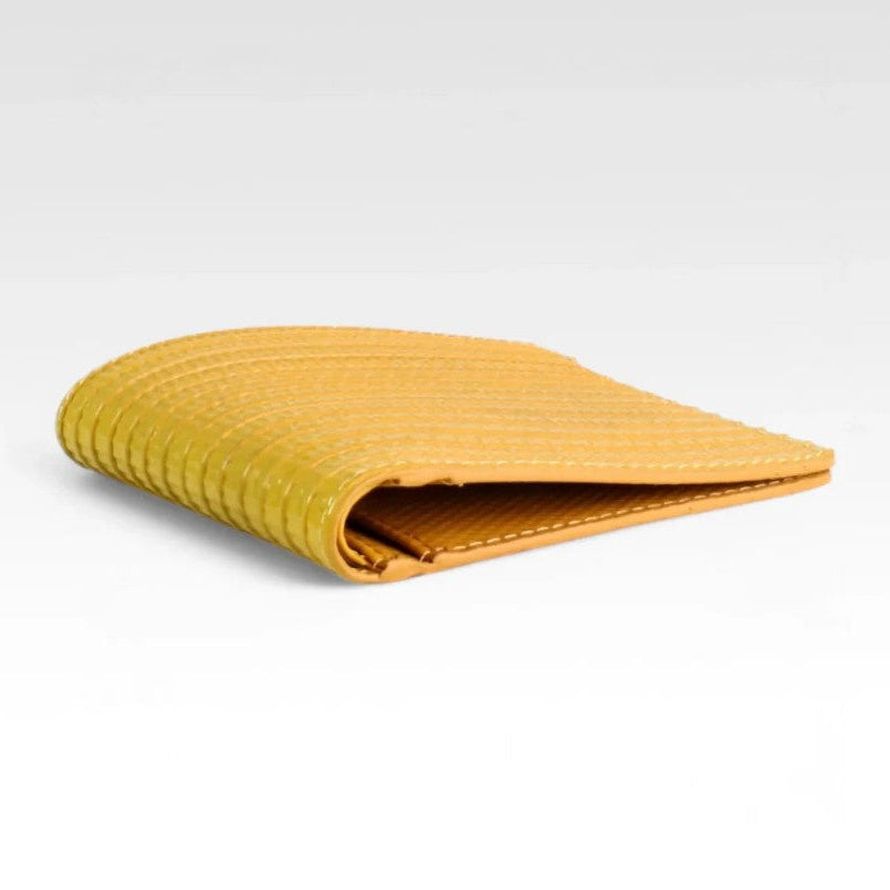 The Elvis and Kresse yellow billfold wallet in front of a white background