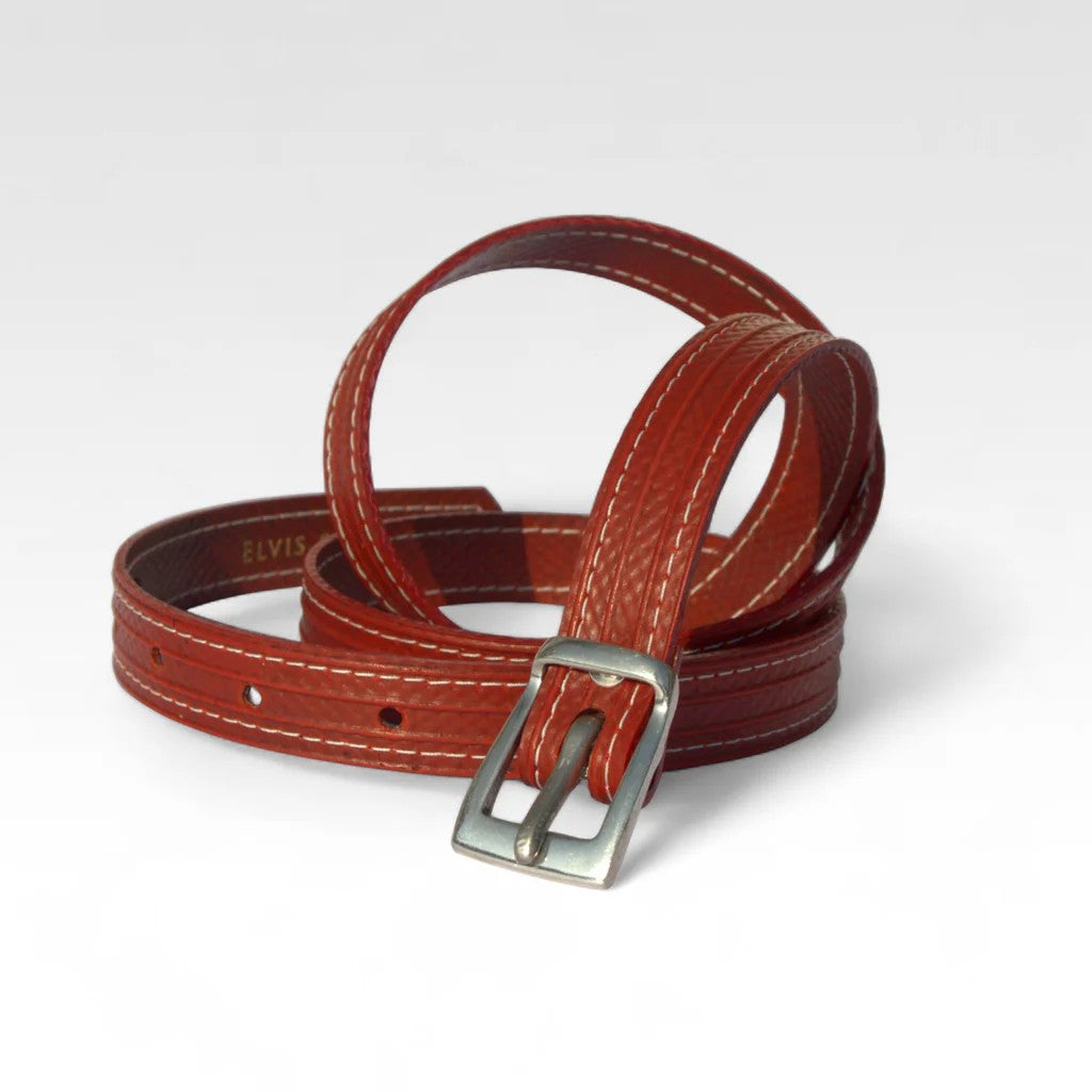 A picture of the red Elvis and Kresse skinny belt on a white background