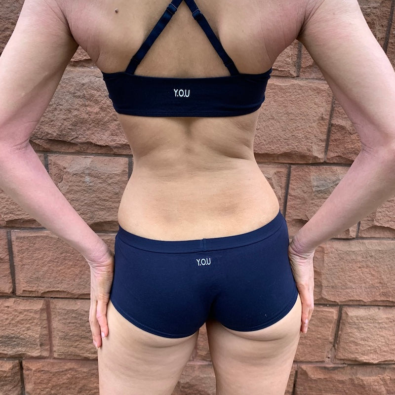 model wearing a navy blue organic cotton matching set with a bralette and boyshorts - You Underwear