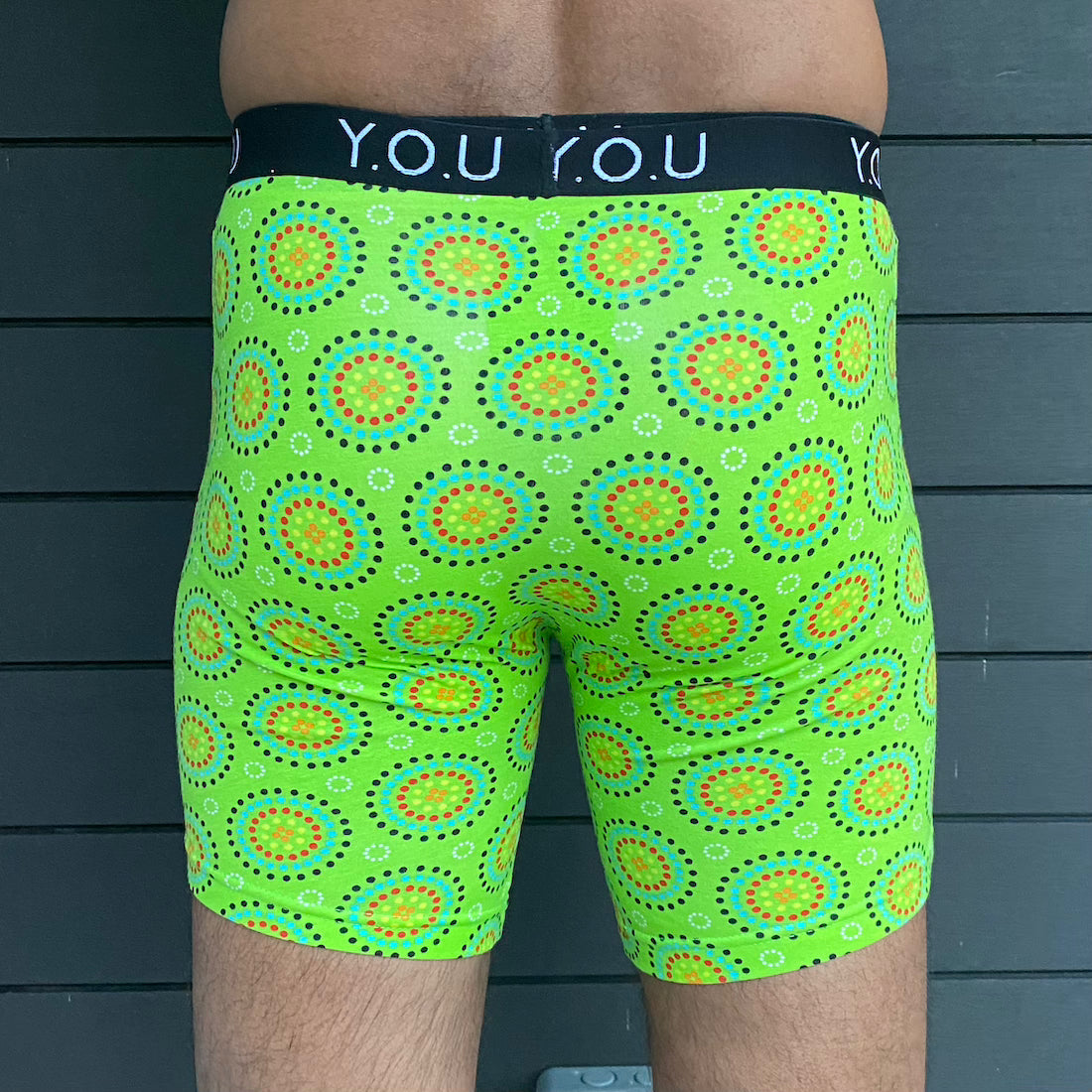 model wearing organic cotton longer leg style trunks in green mara- You Underwear