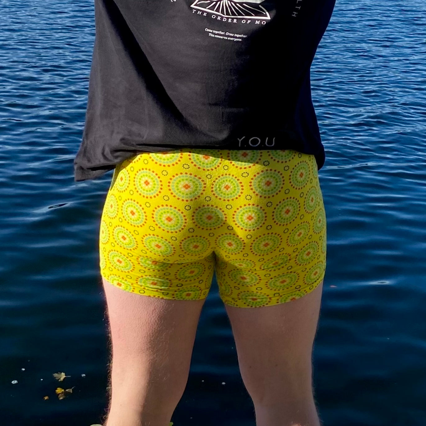 model wearing organic cotton mid length trunks yellow mara - You Underwear