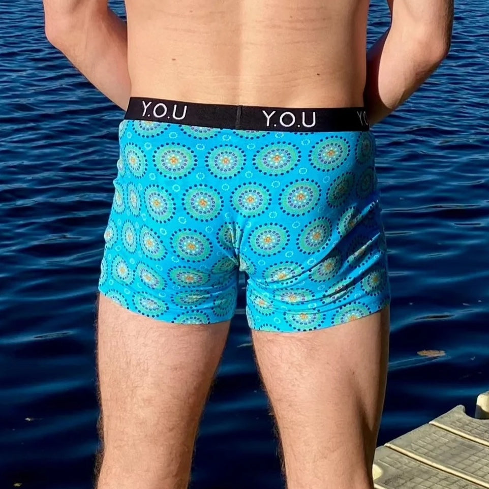 model wearing organic cotton mid length trunks blue mara - You Underwear