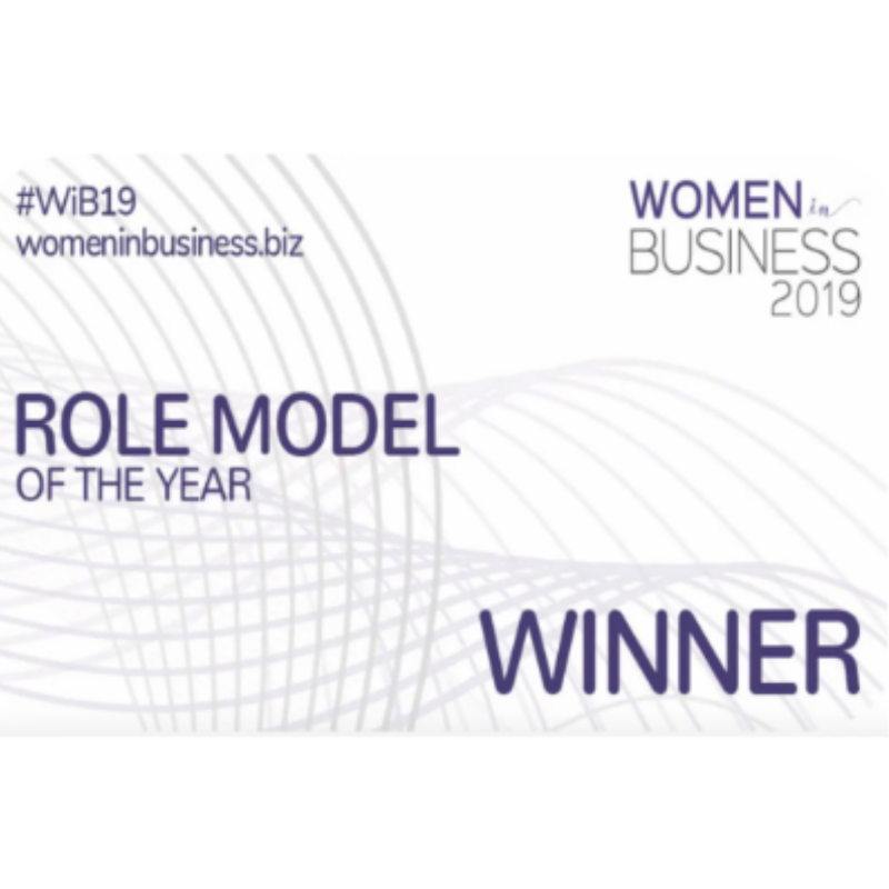 An image which reads 'women in business 2019, role model of the year, winner.' The text is in dark purple, layered over a white and grey line graphic.