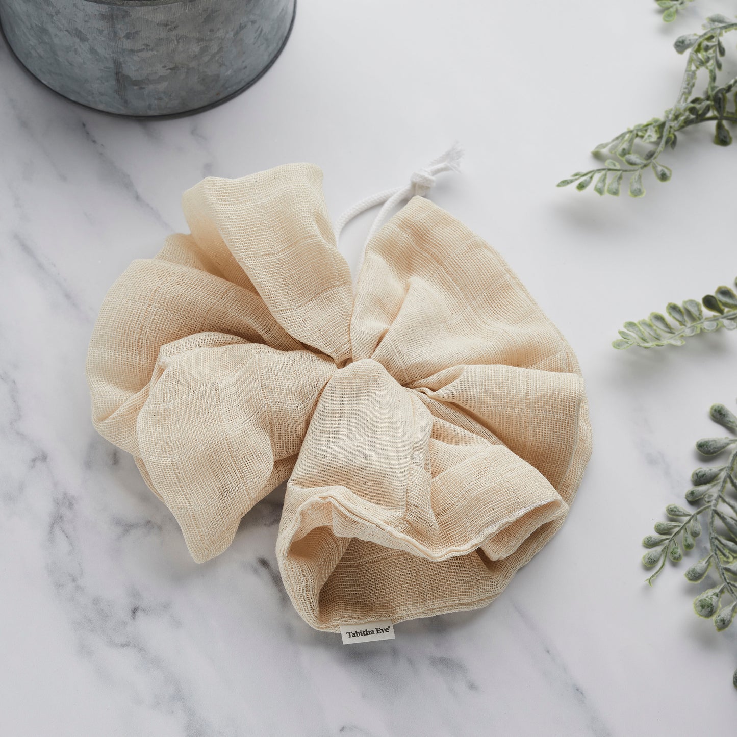 A beige biodegradable bath pouf