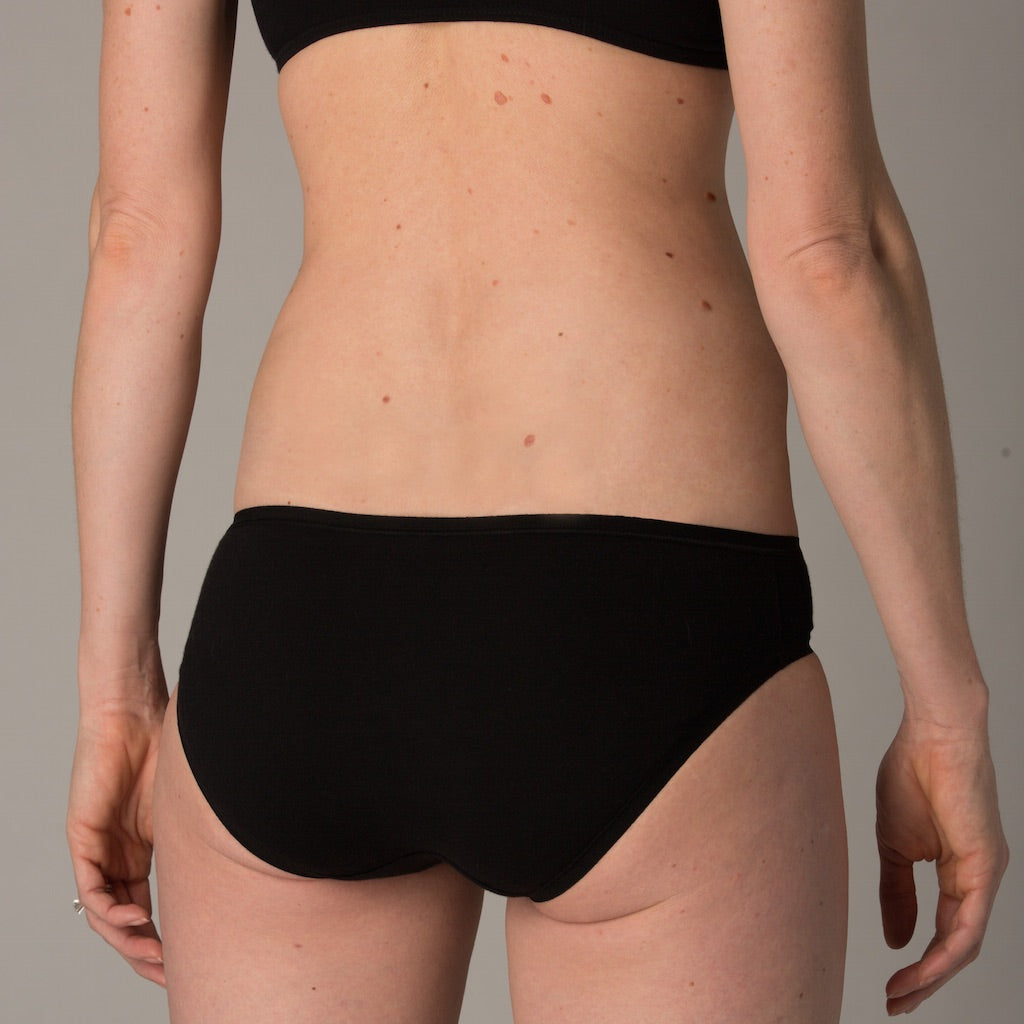 a woman wearing a black bikini turns away from the camera