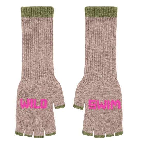 A flat lay photo of the Black & Beech Wild Swim fingerless gloves in beige oatmeal with neon pink writing and sage green cuffs on a white background.