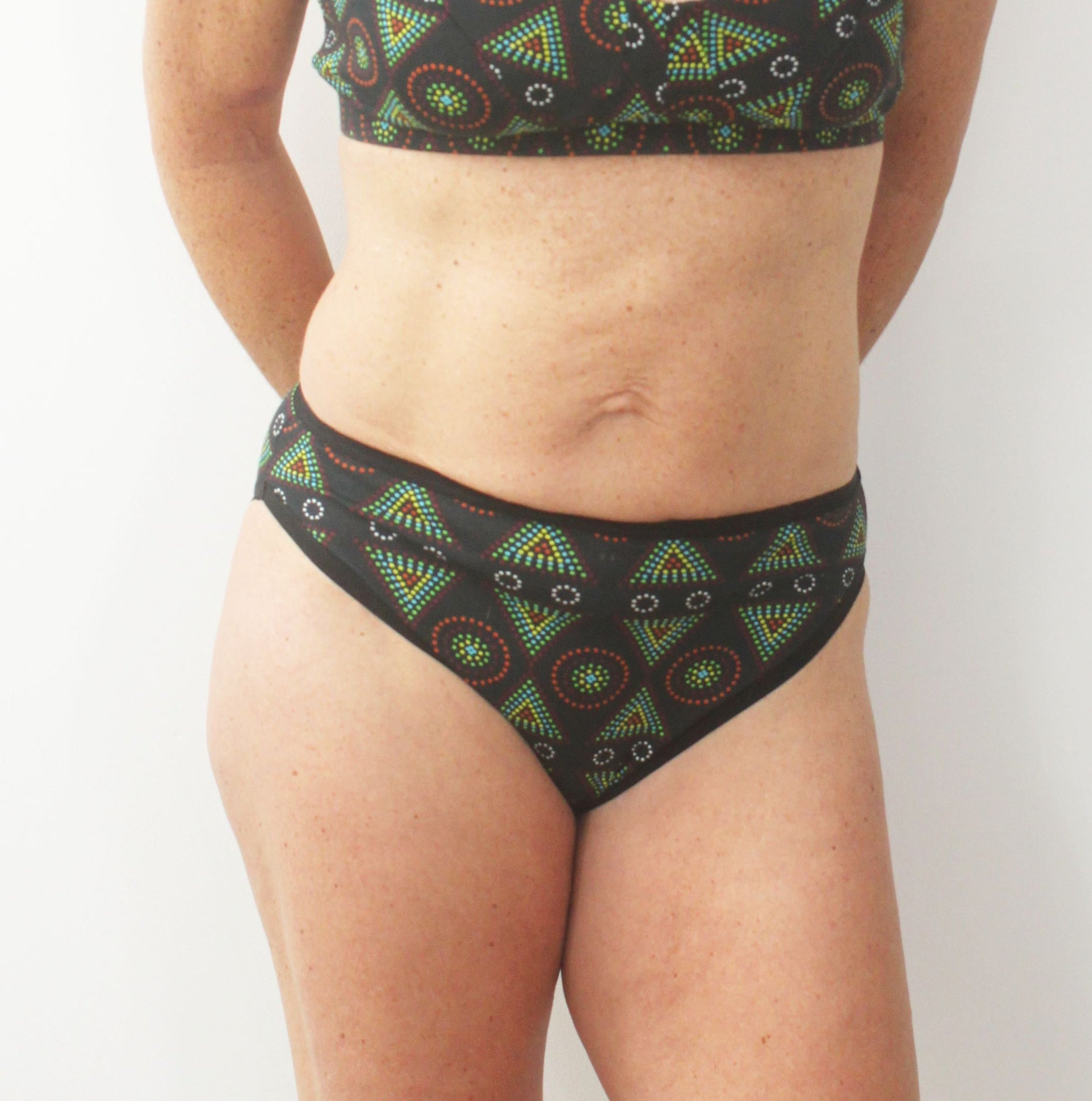 model wearing organic cotton mid rise bikini black mara print - You Underwear