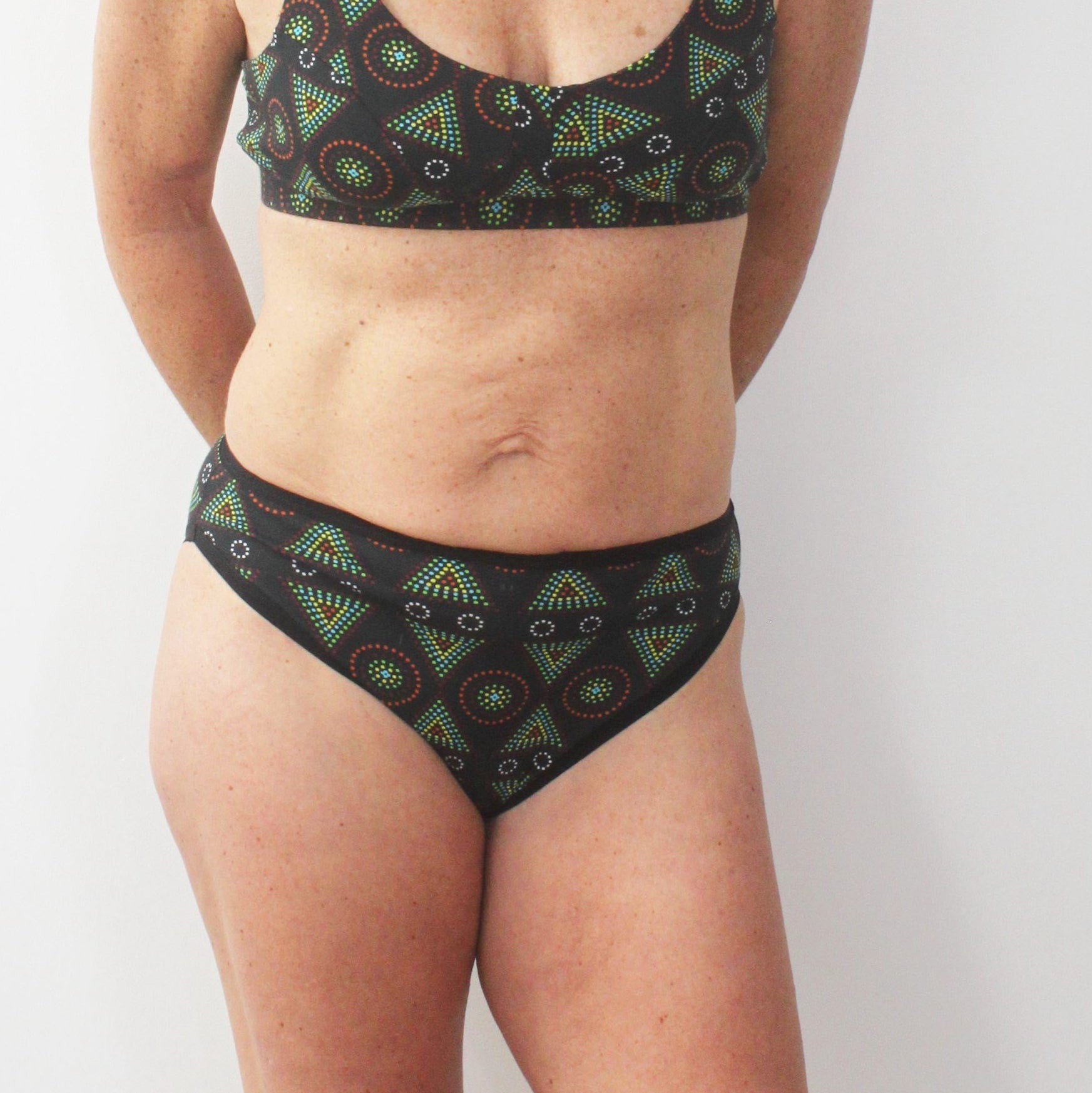 model wearing organic cotton mid rise bikini black mara print - You Underwear