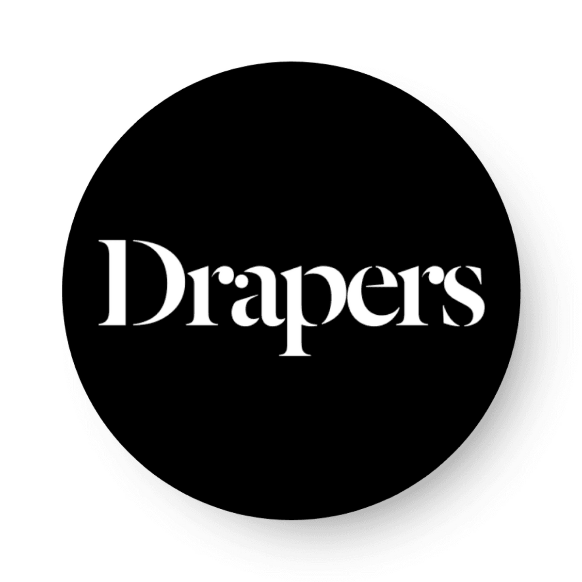 A photo of the Drapers logo. It is a white square with a black circle in the middle. In the circle reads, 'Drapers' in white letter.