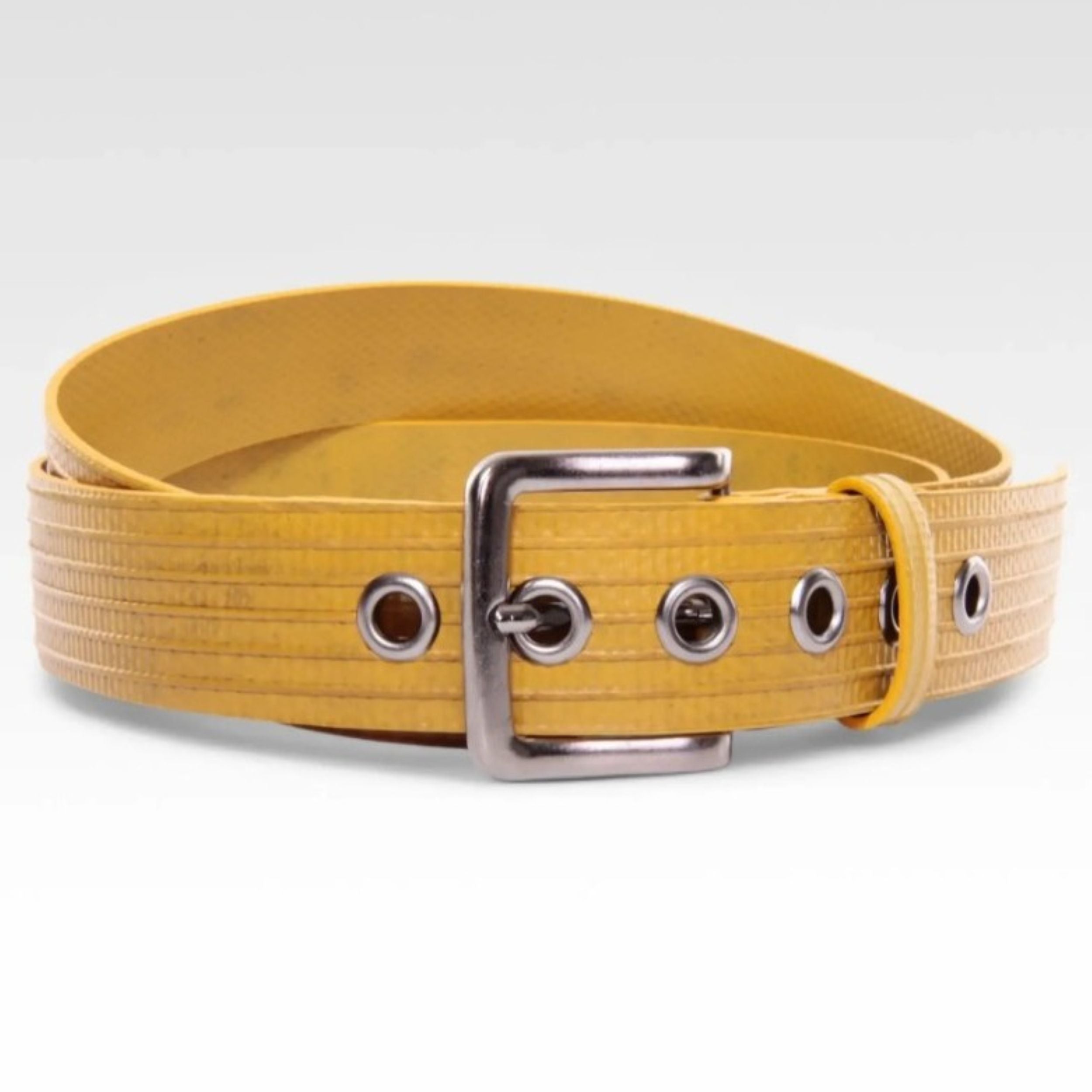 A photo of the Elvis & Kresse big yellow belt, curled into a circle, on a white background.
