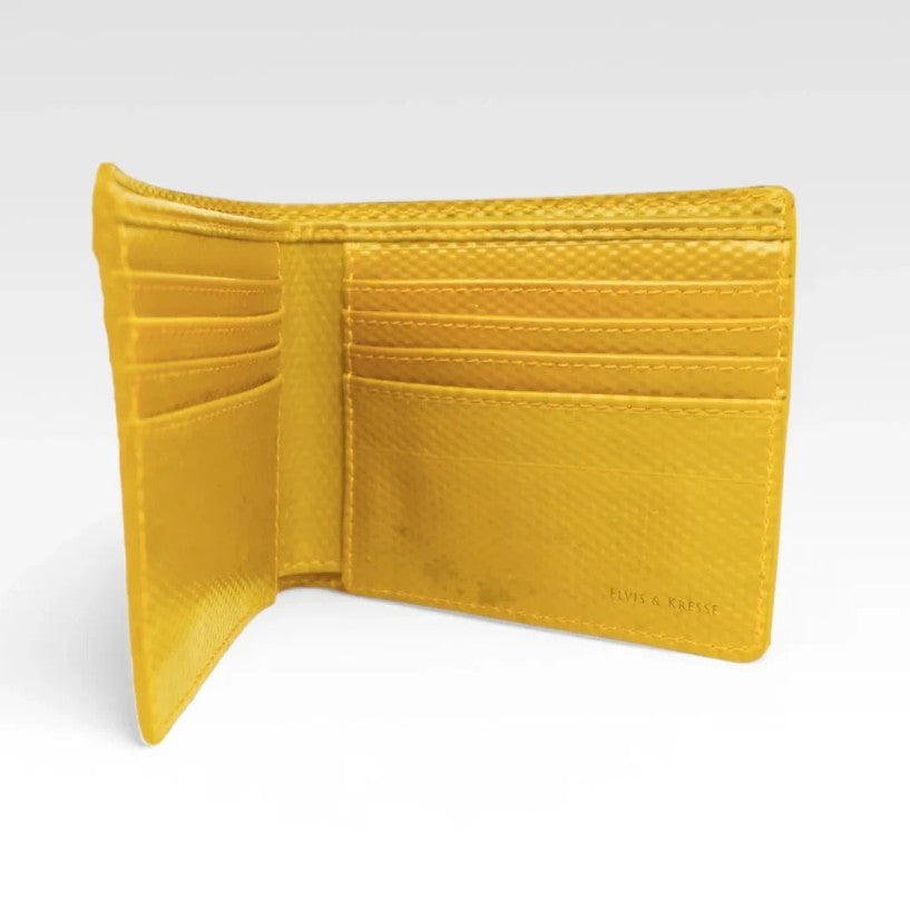 The Elvis and Kresse yellow billfold wallet in front of a white background