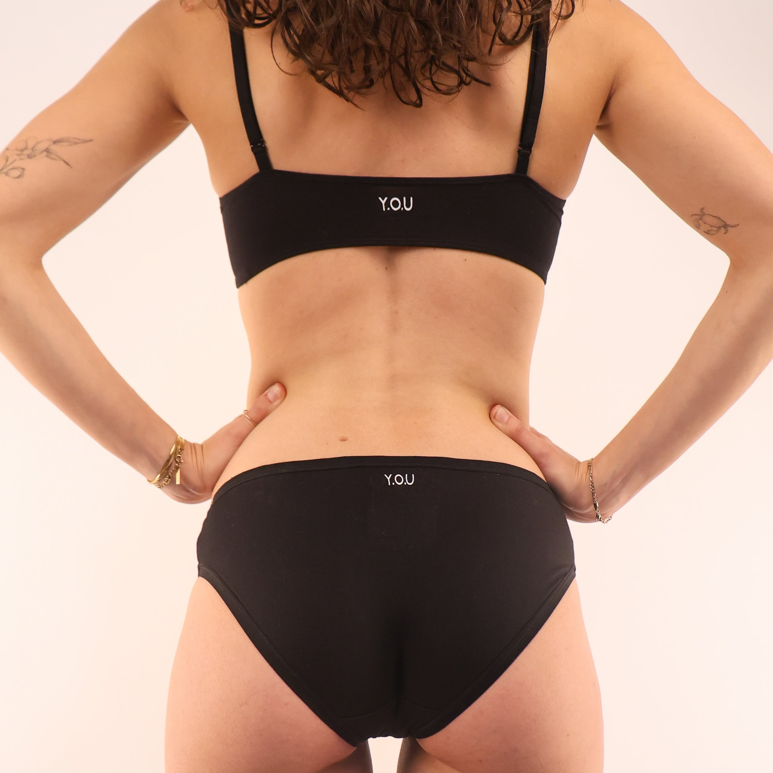model wearing an organic cotton matching set with a black bralette and low rise bikini- You Underwear