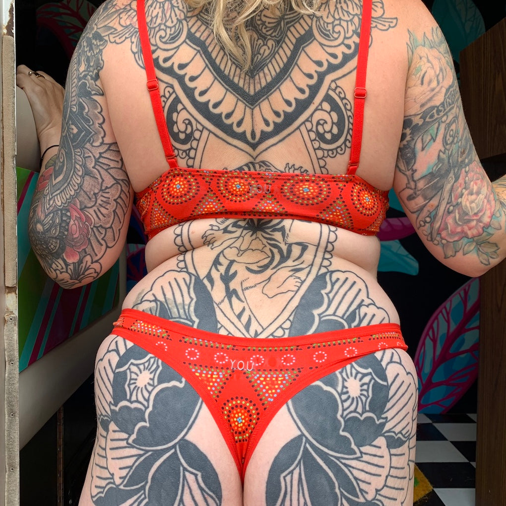 model wearing a red mara patterned organic cotton matching set with a bralette and thong - You Underwear