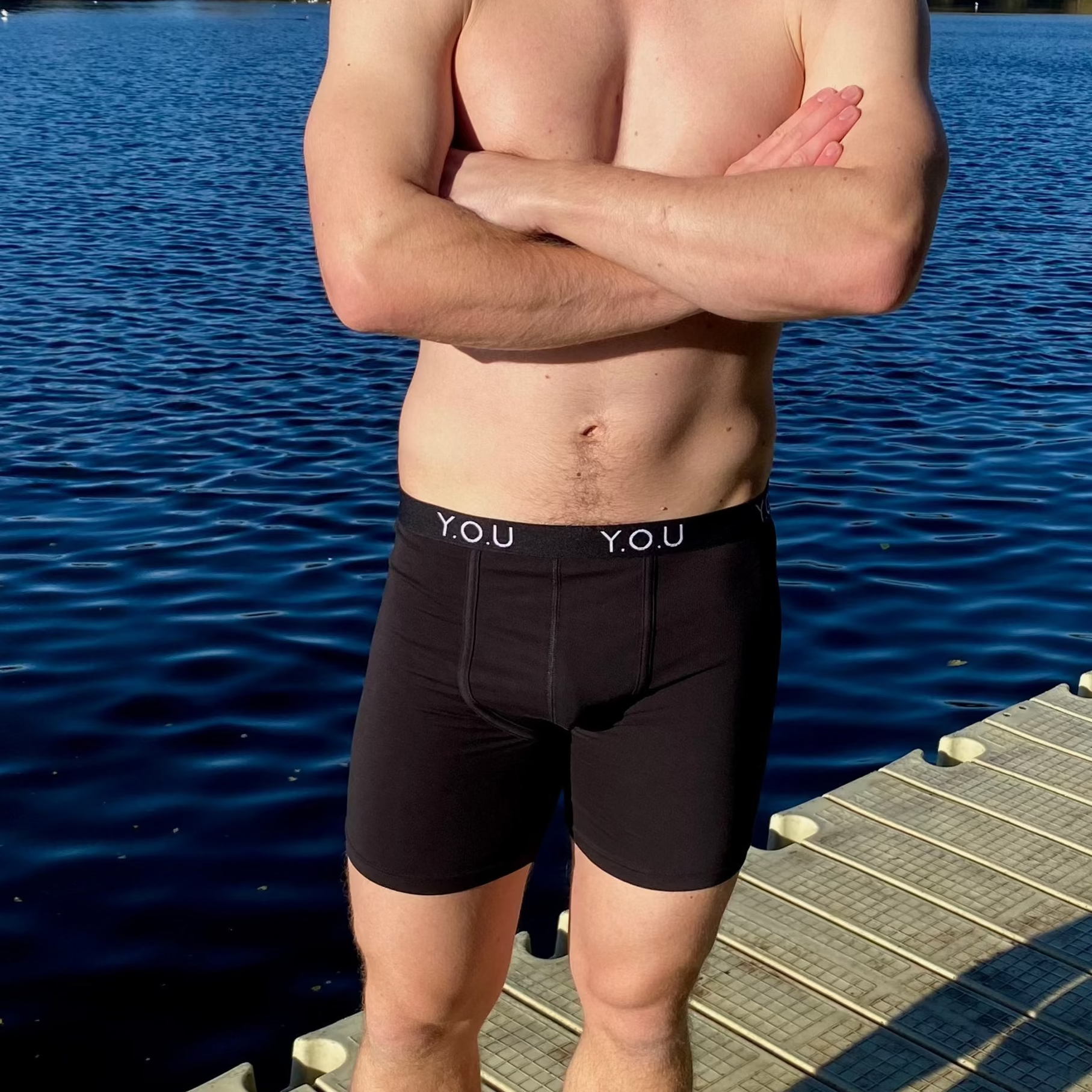 model wearing organic cotton longer leg style trunks in black- You Underwear