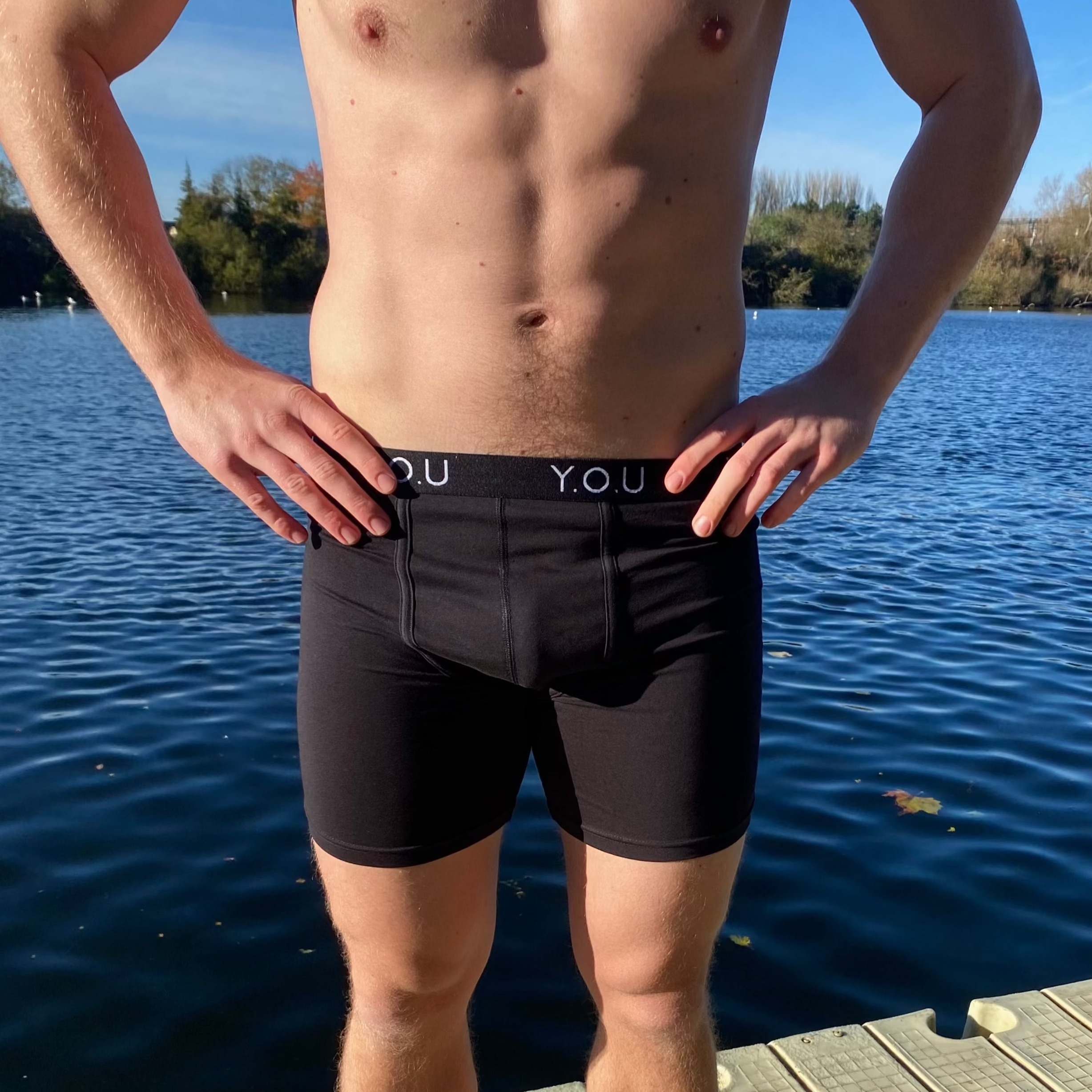 model wearing organic cotton longer leg style trunks in black- You Underwear