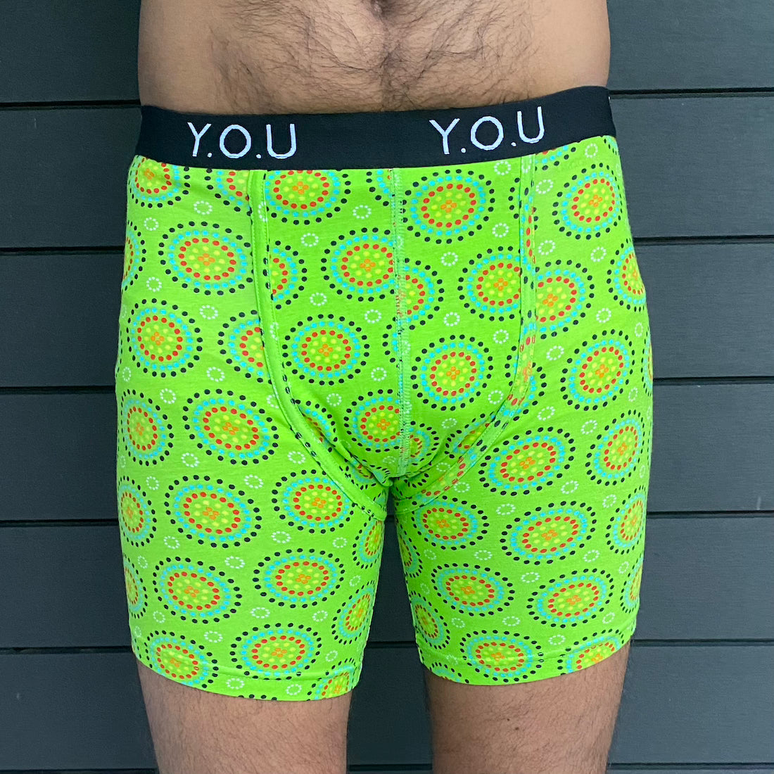 model wearing organic cotton longer leg style trunks in green mara- You Underwear