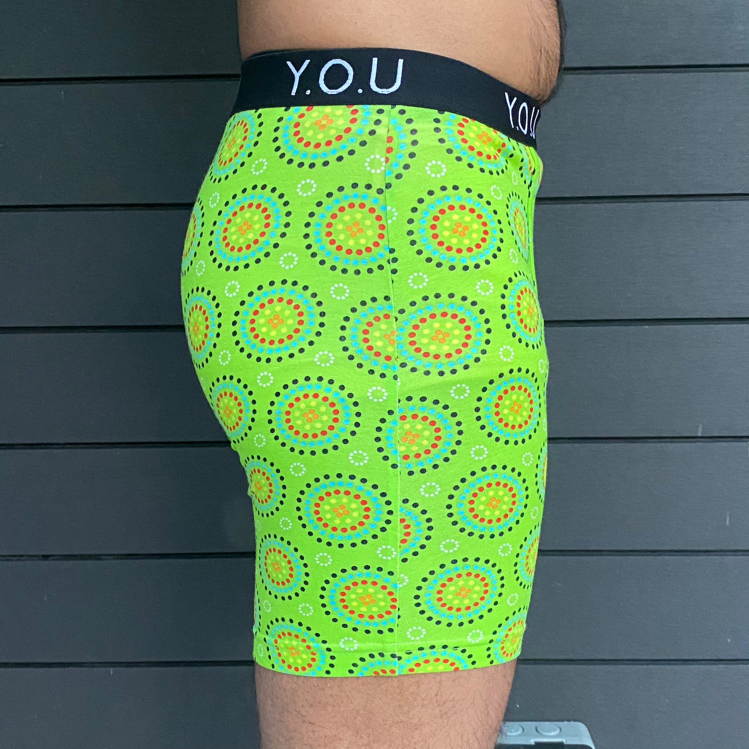 model wearing organic cotton longer leg style trunks in green mara- You Underwear