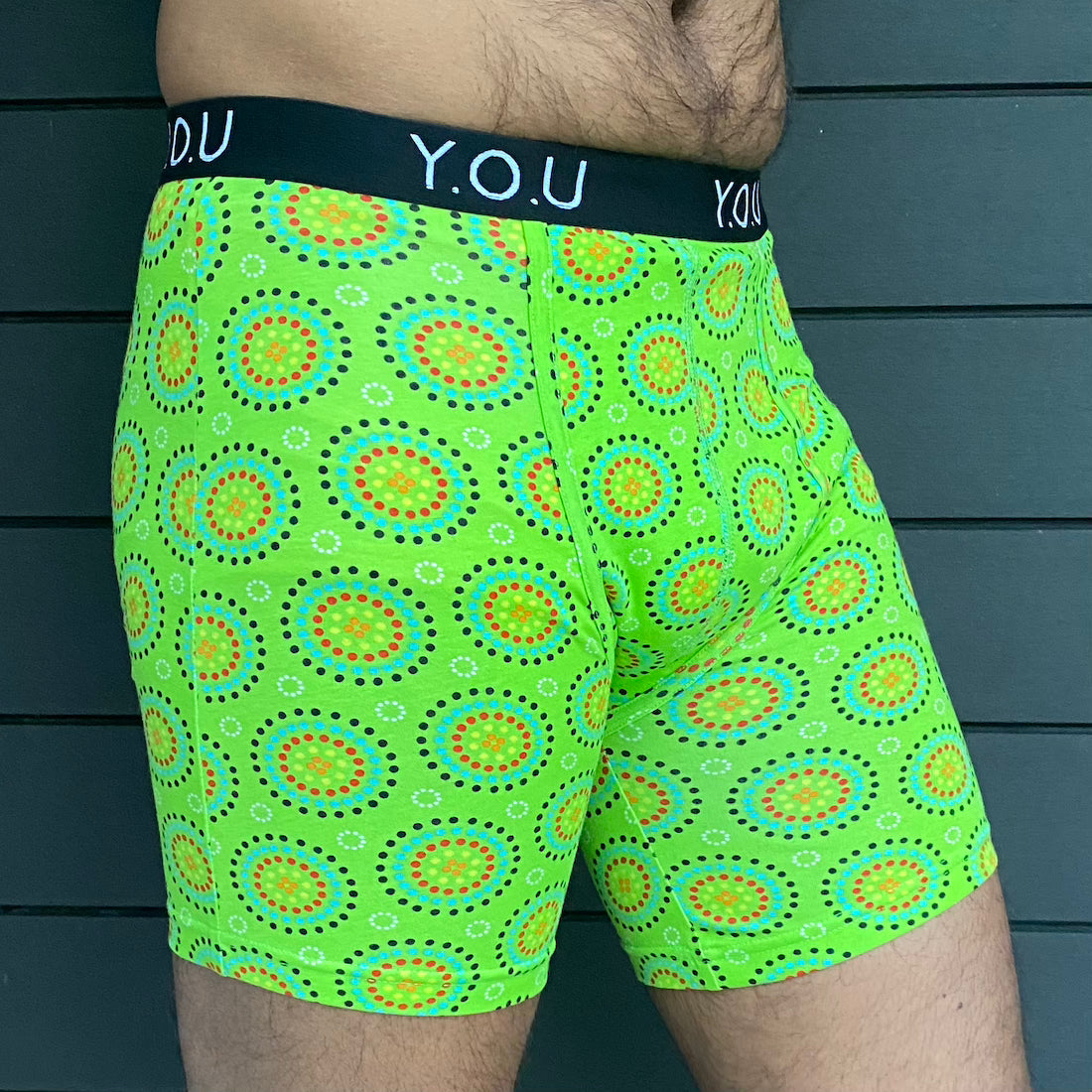 model wearing organic cotton longer leg style trunks in green mara- You Underwear