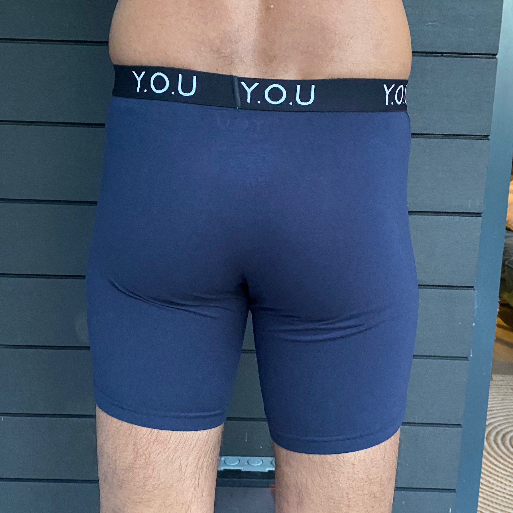 model wearing organic cotton longer leg style trunks in navy - You Underwear