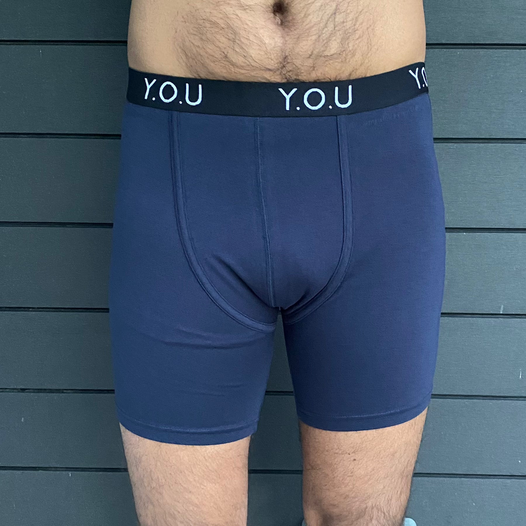 model wearing organic cotton longer leg style trunks in navy - You Underwear