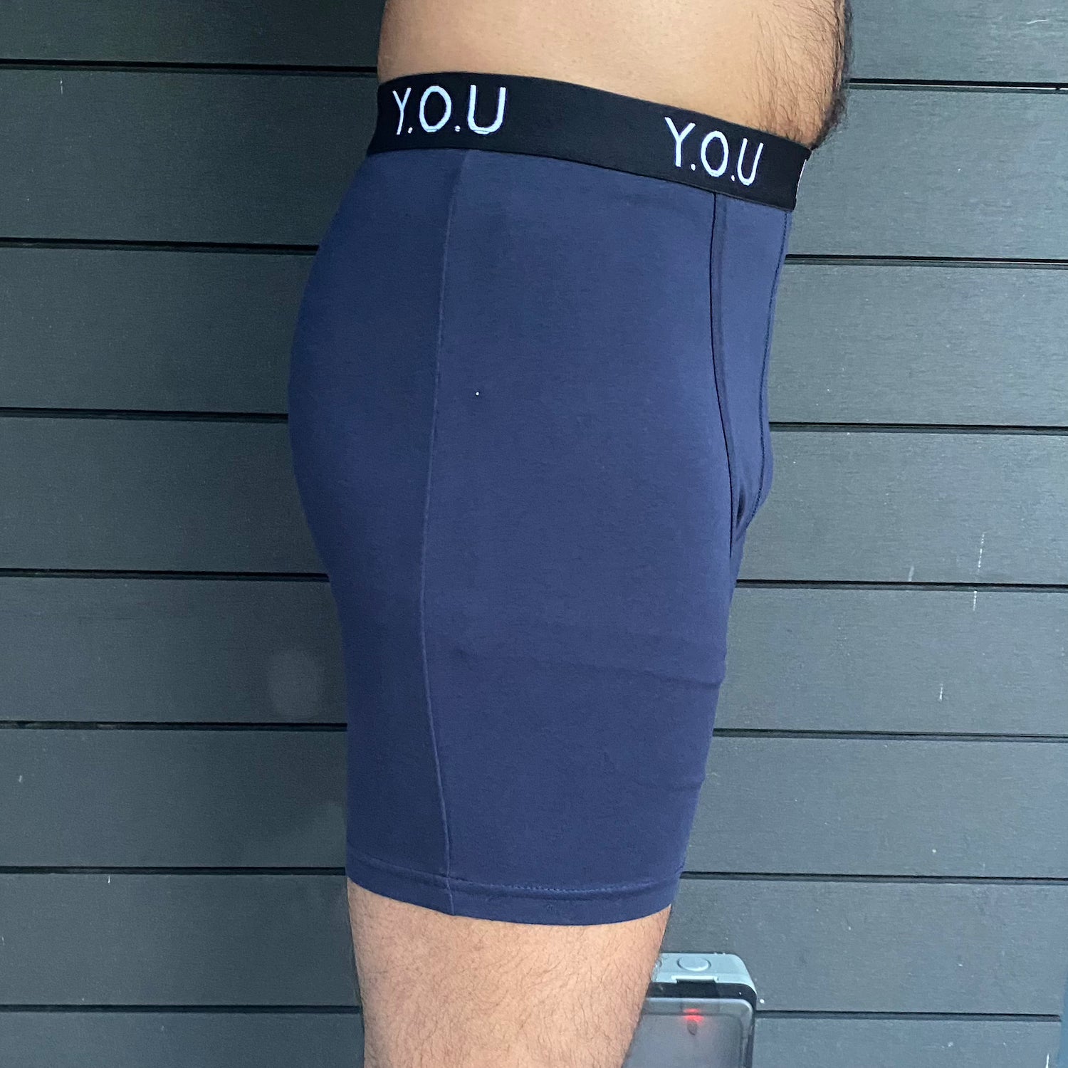 model wearing organic cotton longer leg style trunks in navy - You Underwear