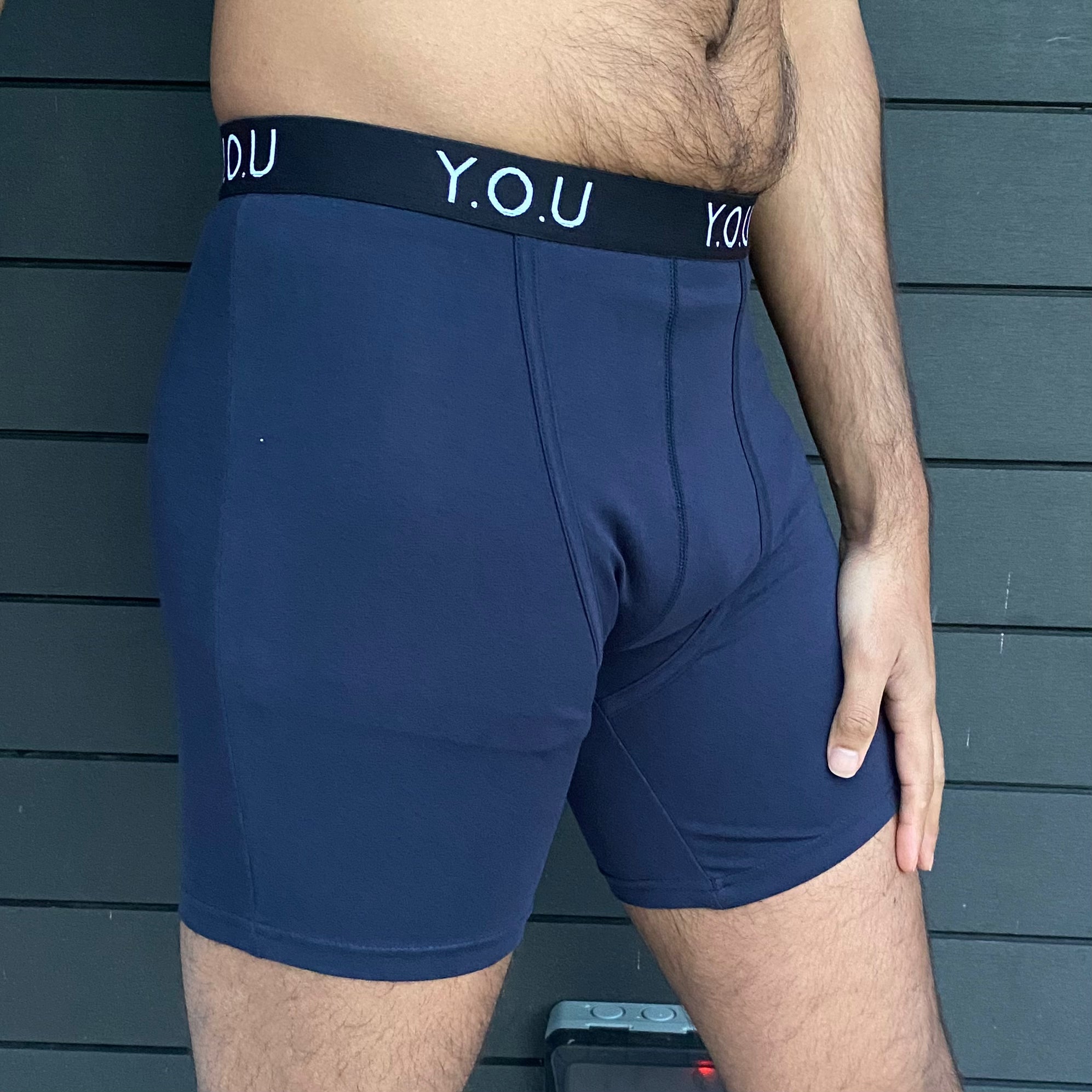 model wearing organic cotton longer leg style trunks in navy - You Underwear