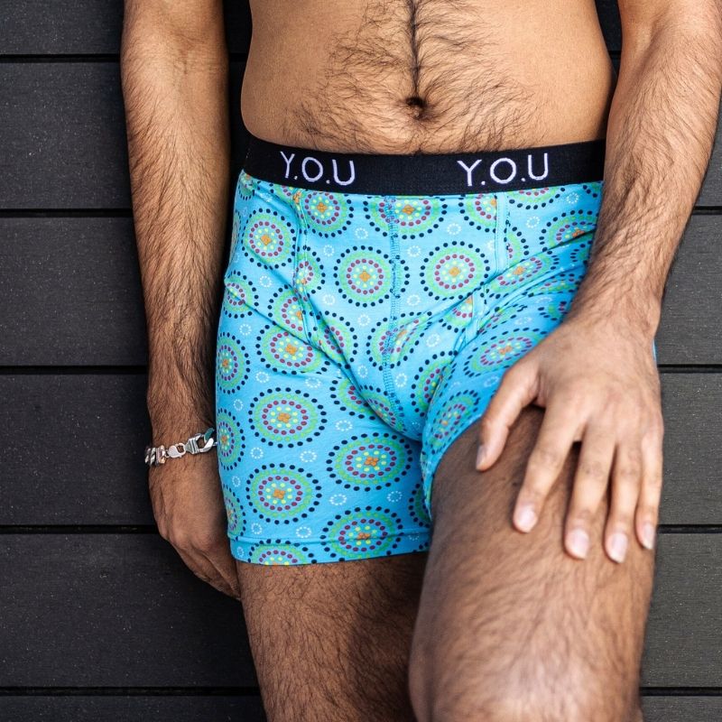 man wearing longer leg boxers in blue mara print