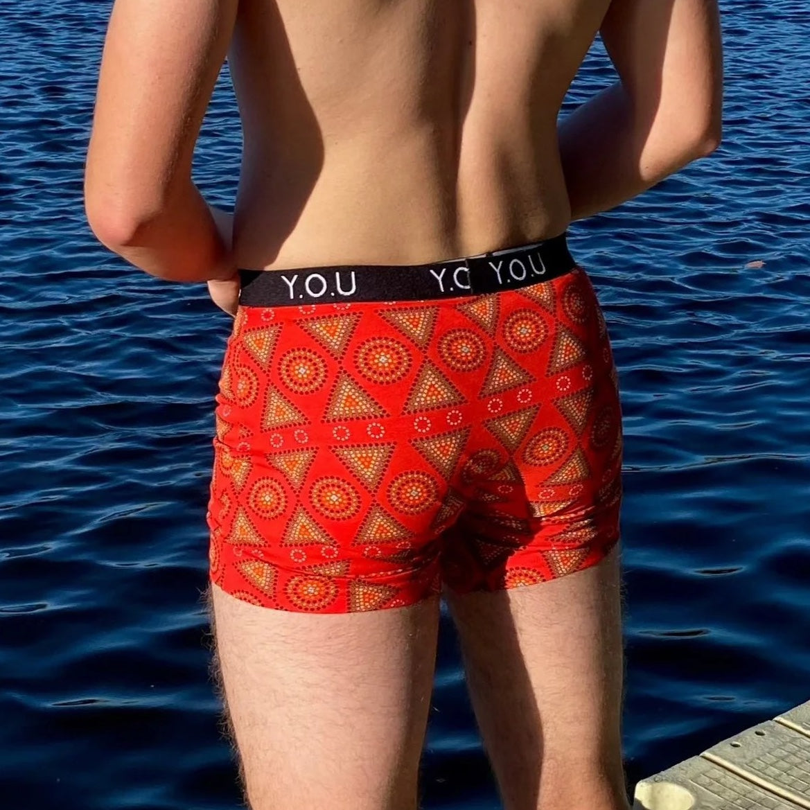 model wearing organic cotton mid length trunks red mara - You Underwear