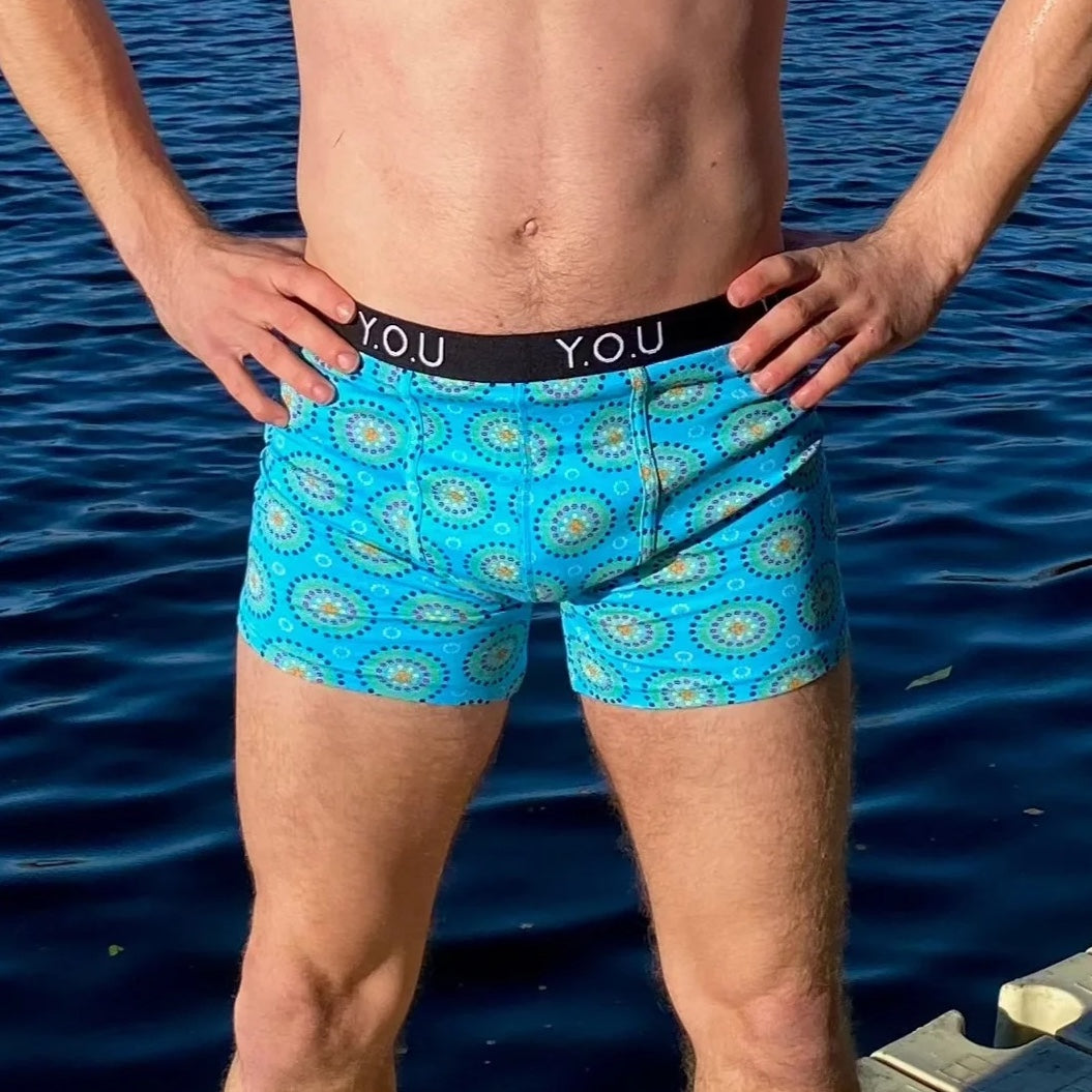 model wearing organic cotton mid length trunks blue mara - You Underwear