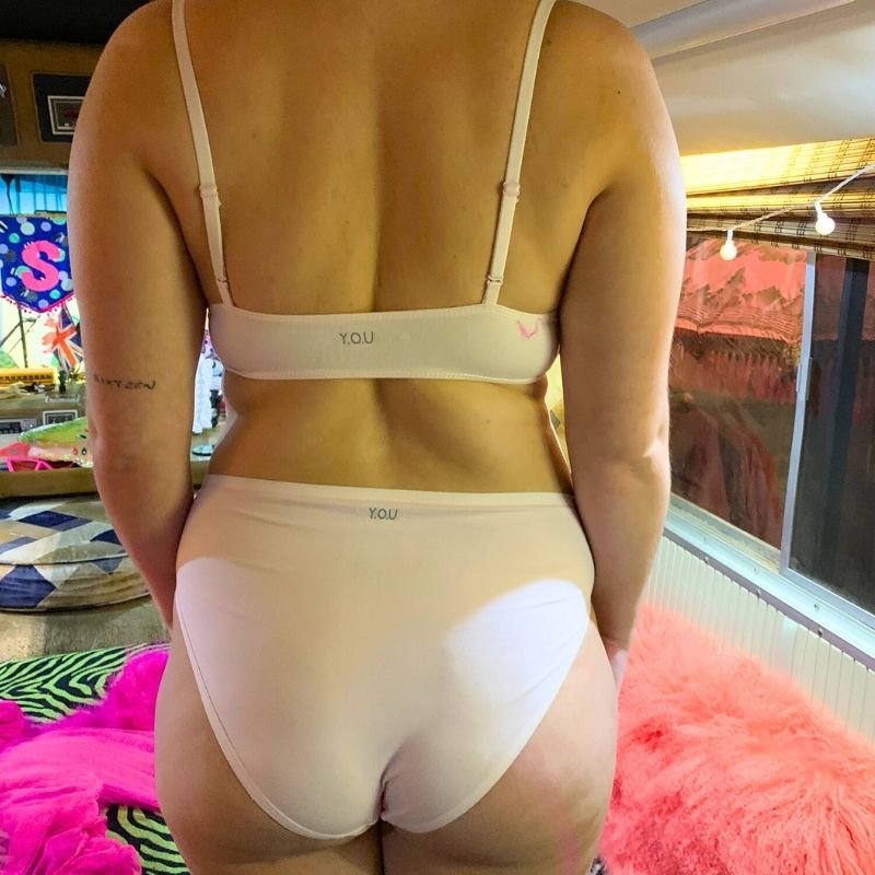 model wearing a light pink organic cotton matching set with a bralette and mid rise bikini knickers - You Underwear