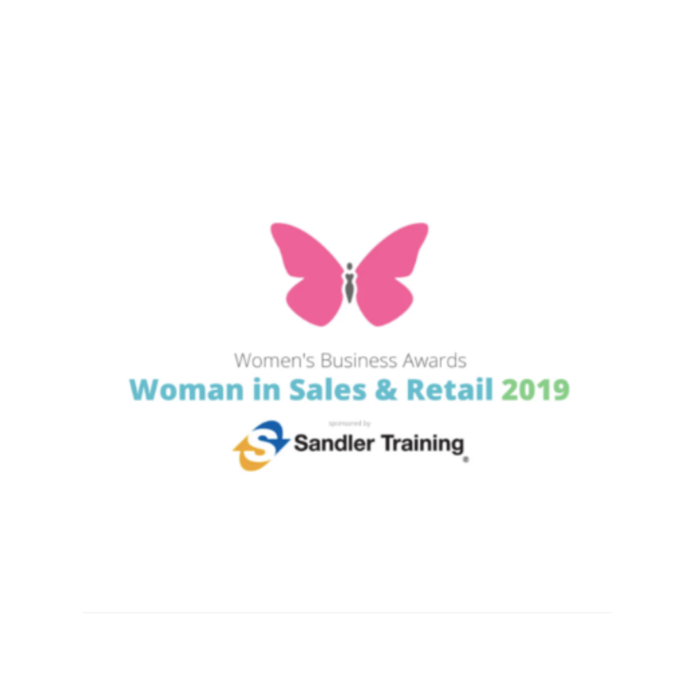 An image which reads 'Women's Business Awards, Women in sales and retail 2019, Sandler training.' The image background in white and there is a bright pink butterfly n the top center of the image. The text is in grey, black, blue and green.
