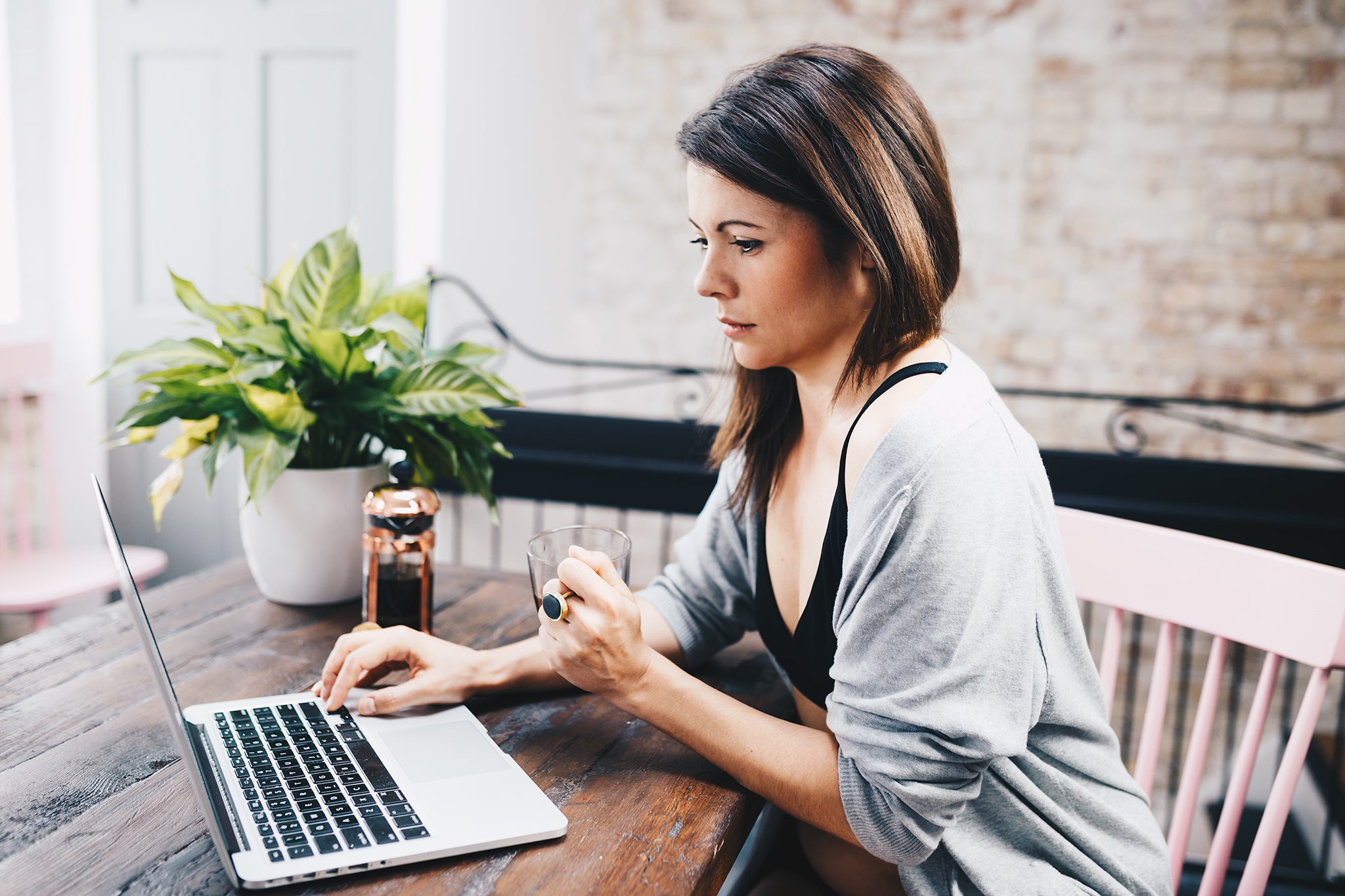 A woman looks at her laptop