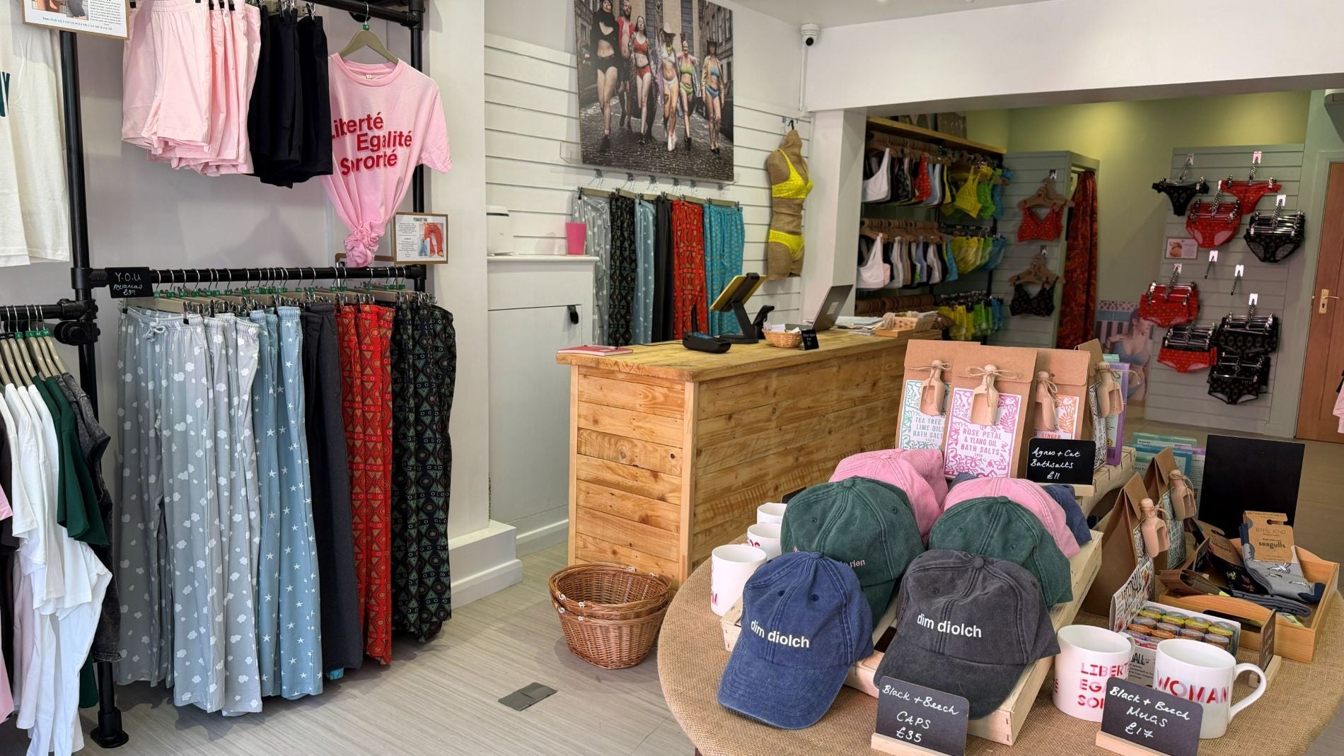 A photo of the new YOU Underwear Brighton store. The photo shows the inside of the store with clothing rails on the left, a central table, a till desk  and more clothes rails in the background.