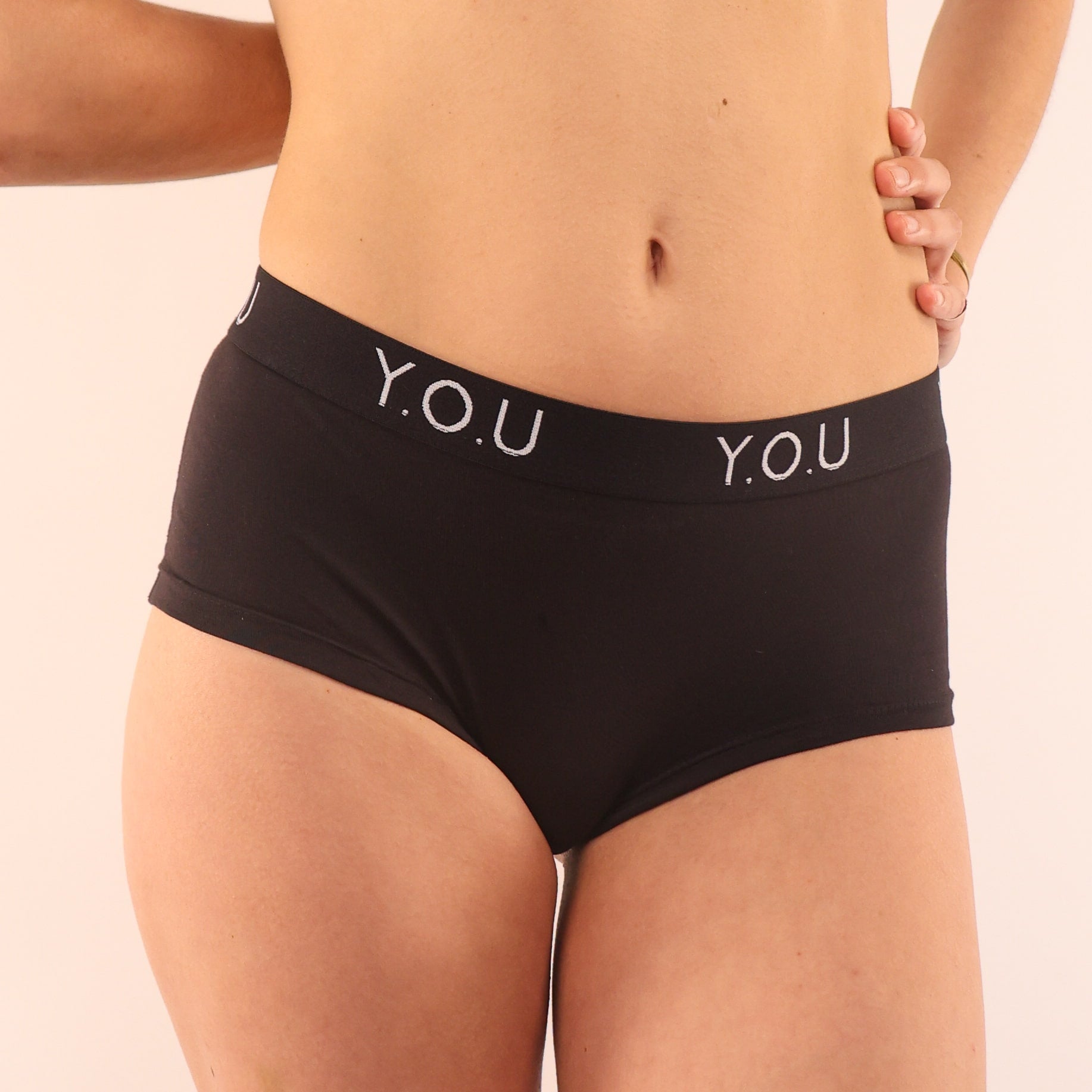 Model wearing organic cotton YOU branded boyshorts in black- You Underwear