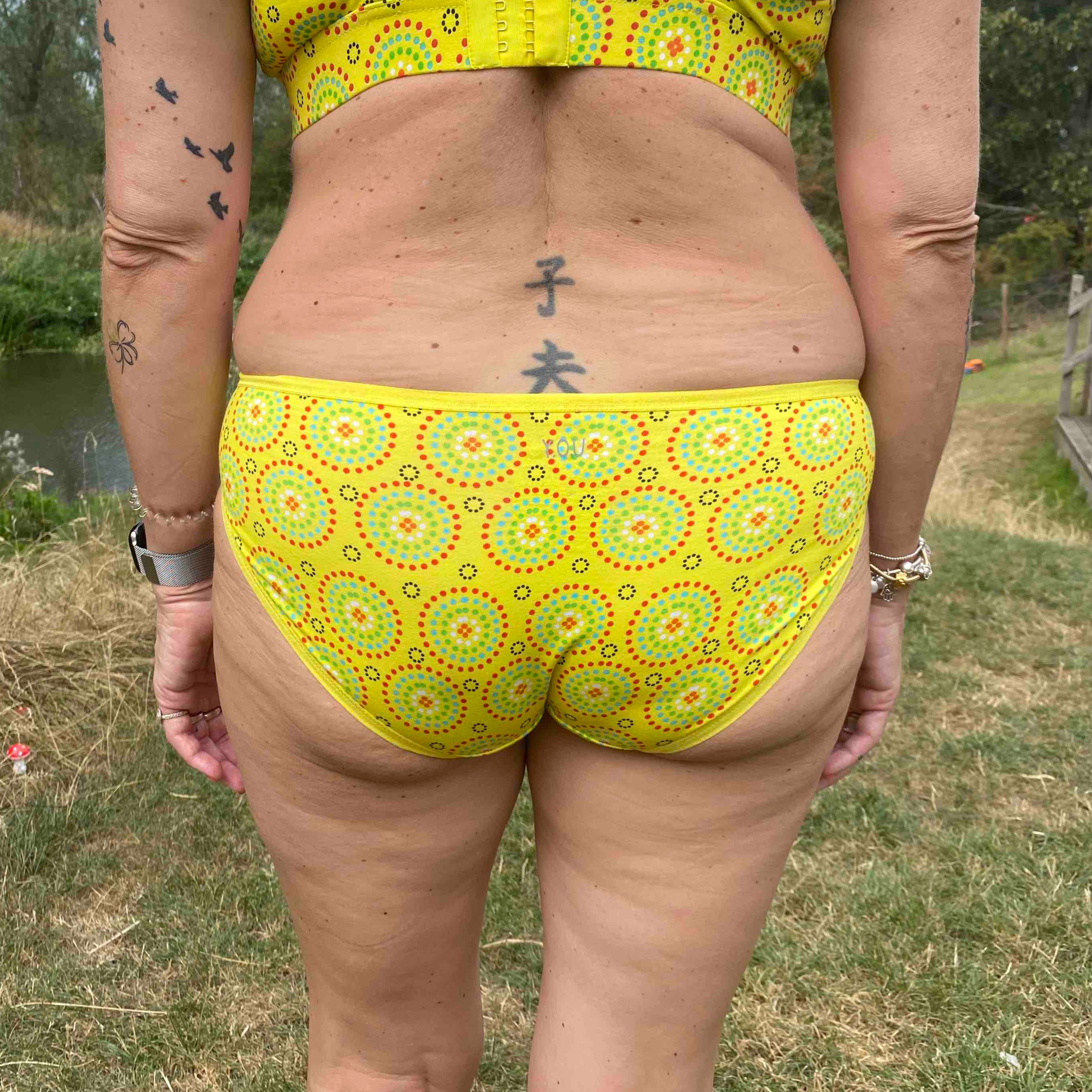 model wearing organic low rise bikini yellow mara print - You Underwear