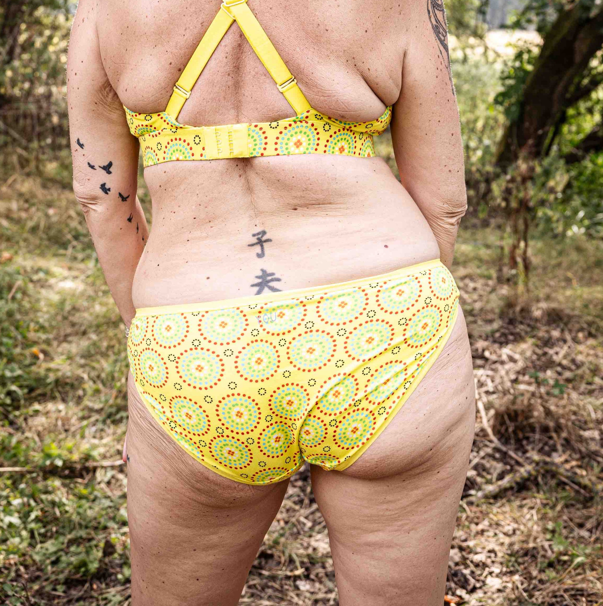 model wearing organic cotton low rise bikini yellow mara print, shown from behind - You Underwear