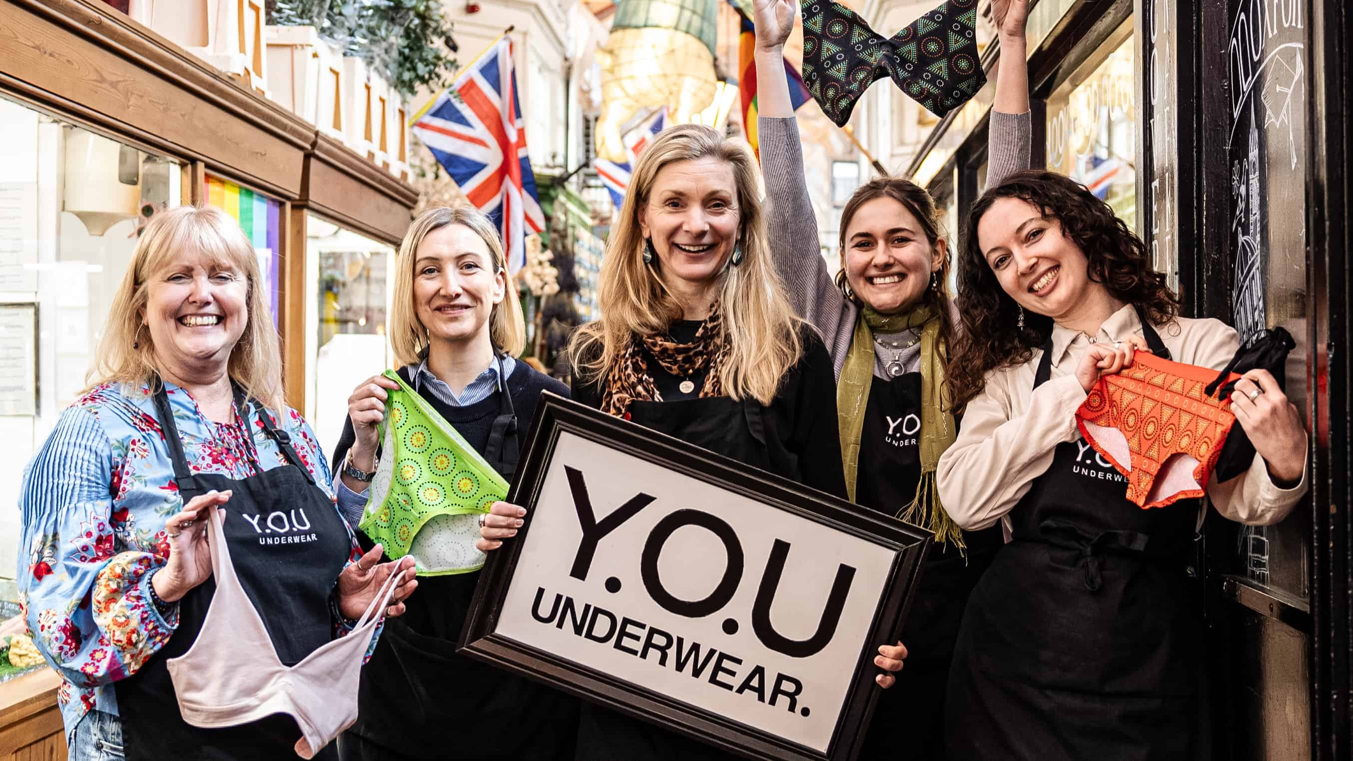 Five people from the You Oxford Team standing in the covered market smiling