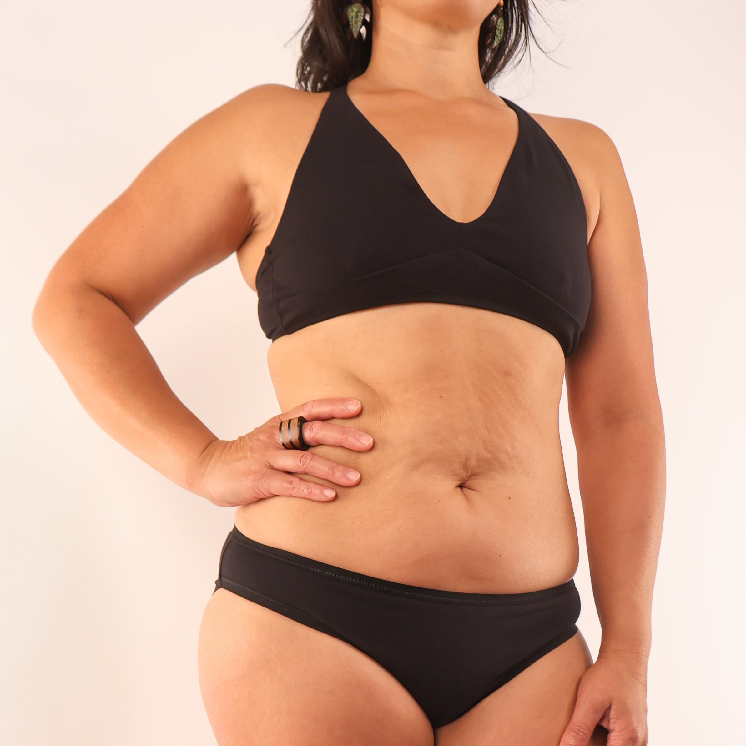 model wearing an organic cotton matching set with a black bralette and low rise bikini- You Underwear
