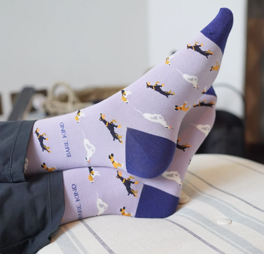 Bare Kind socks - Save the Dogs person  wearing socks sitting with feet up