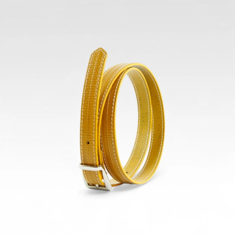 A picture of the yellow Elvis and Kresse skinny belt on a white background
