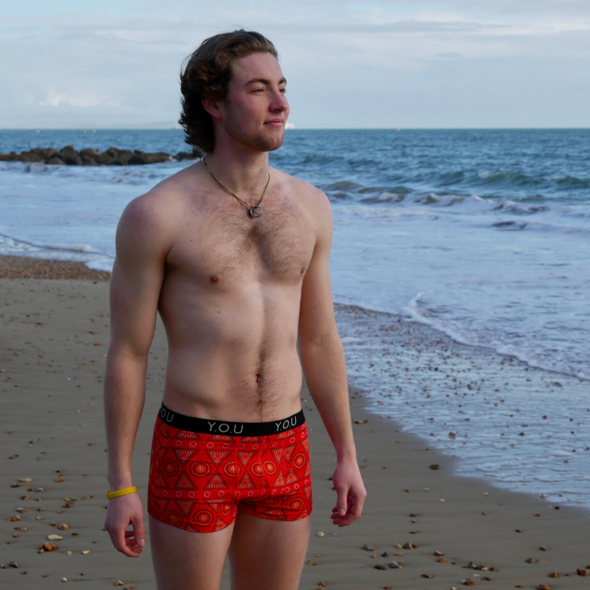 Men's trunks - Red Mara design - lifestyle shot on the beach