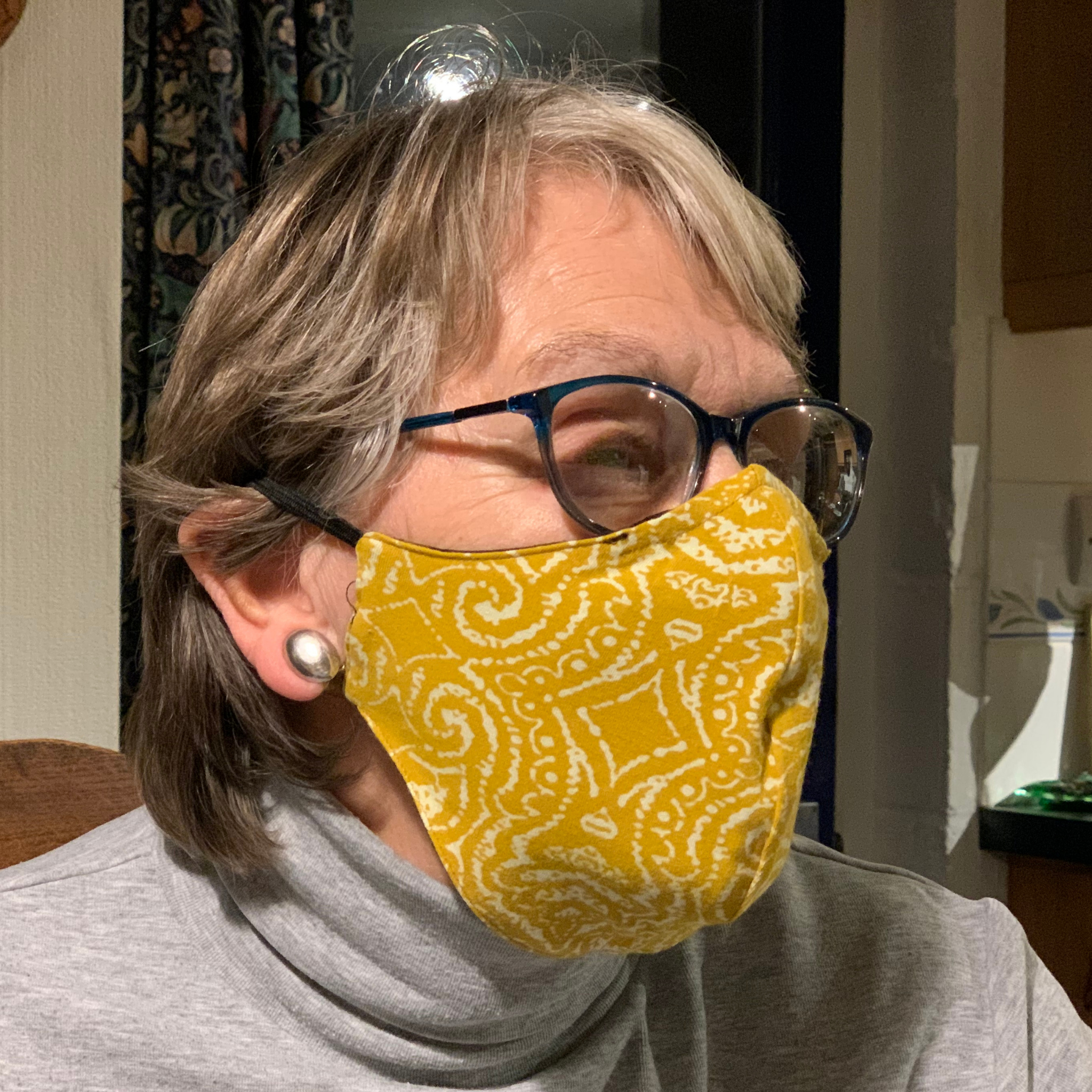 Y.O.U face mask with a mustard yellow design