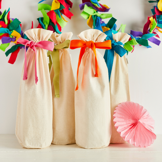 4 neutral cloth bottle bags with brightly coloured ribbons