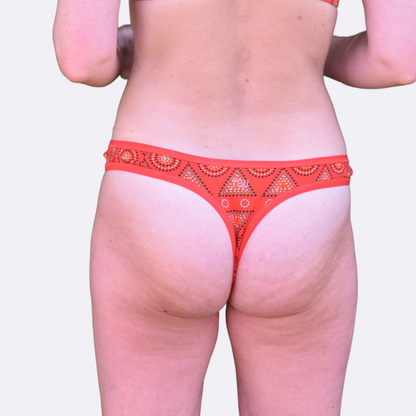 Lady wearing a red Mara thong, back view